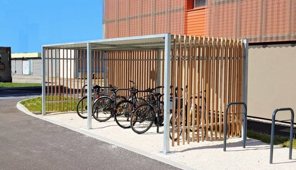 Open wooden bike shelter after three years of use, with parked bikes